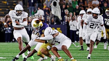 Sep 13, 2025; South Bend, Indiana, USA; Notre Dame Fighting Irish tight end Eli Raridon (9) makes a catch as Texas A&M Aggies safety Bryce Anderson (1) defends during the second half at Notre Dame Stadium. Mandatory Credit: Trevor Ruszkowski-Imagn Images