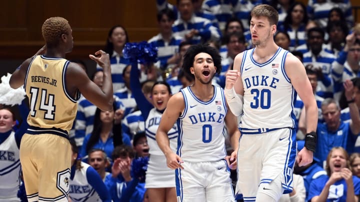 Jan 13, 2024; Durham, North Carolina, USA; Duke Blue Devils center Kyle Filipowski (30) reacts after scoring as Georgia Tech Yellow Jackets guard Kowacie Reeves Jr. (14) and Duke guard Jared McCain (0) look on during the first half at Cameron Indoor Stadium. Mandatory Credit: Rob Kinnan-USA TODAY Sports