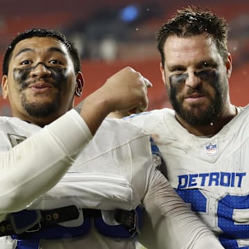 Nov 9, 2025; Landover, Maryland, USA; Detroit Lions offensive tackle Penei Sewell (L) celebrates with Lions offensive tackle Taylor Decker (68) while leaving the field after their game against the Washington Commanders at Northwest Stadium. Mandatory Credit: Geoff Burke-Imagn Images