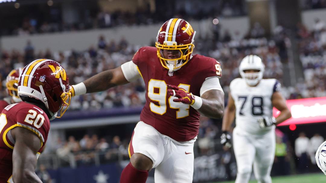 Sep 20, 2026; Arlington, Texas, USA;  Dallas Cowboys quarterback Dak Prescott (4) is tackled after running the ball against Washington Commanders safety Jeremy Reaves (39) and defensive tackle Daron Payne (94) during the first quarter at AT&T Stadium.  Mandatory Credit: Kevin Jairaj-Imagn Images