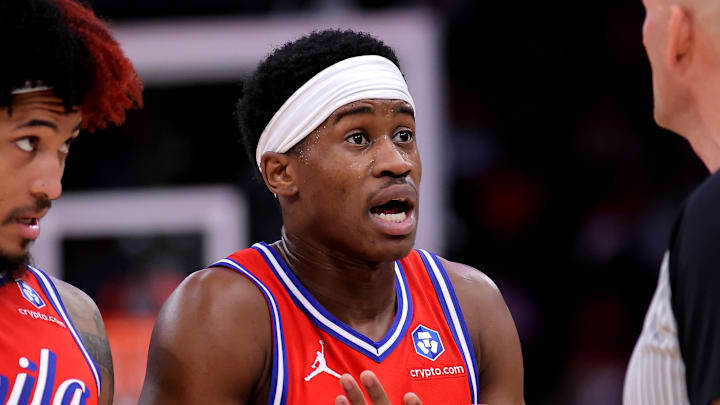 Apr 9, 2026; Houston, Texas, USA; Philadelphia 76ers guard VJ Edgecombe (77) and forward Kelly Oubre Jr. (9) talk with NBA referee Eric Dalen (37) during the second quarter against the Houston Rockets at Toyota Center. Mandatory Credit: Erik Williams-Imagn Images
