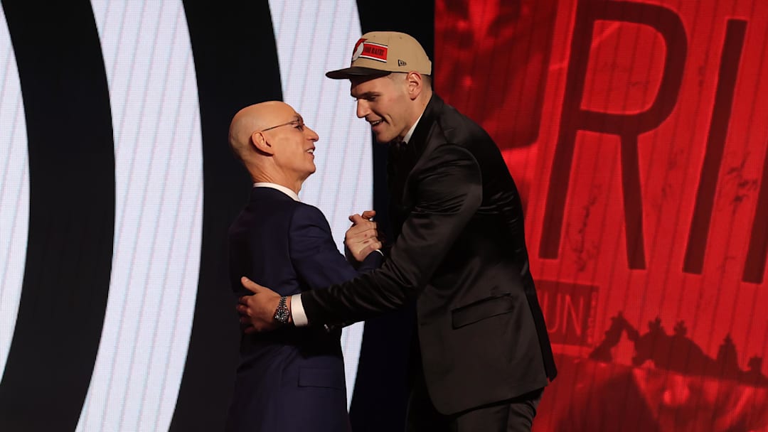 Jun 26, 2024; Brooklyn, NY, USA; Donovan Clingan shakes hands with NBA commissioner Adam Silver after being selected in the first round by the Portland Trail Blazers in the 2024 NBA Draft at Barclays Center. Mandatory Credit: Brad Penner-Imagn Images