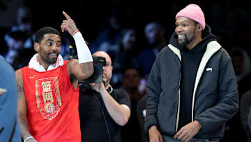 Jan 26, 2023; Brooklyn, New York, USA; Brooklyn Nets guard Kyrie Irving (11) and forward Kevin Durant (7) react after being announced as 2013 all stars during the second quarter against the Detroit Pistons at Barclays Center. Mandatory Credit: Brad Penner-Imagn Images