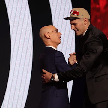 Jun 26, 2024; Brooklyn, NY, USA; Donovan Clingan shakes hands with NBA commissioner Adam Silver after being selected in the first round by the Portland Trail Blazers in the 2024 NBA Draft at Barclays Center. Mandatory Credit: Brad Penner-Imagn Images