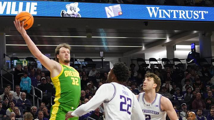 Feb 28, 2026; Evanston, Illinois, USA; Northwestern Wildcats forward Arrinten Page (22) defends Oregon Ducks center Nate Bittle (32) during the first half at Welsh-Ryan Arena. Mandatory Credit: David Banks-Imagn Images
