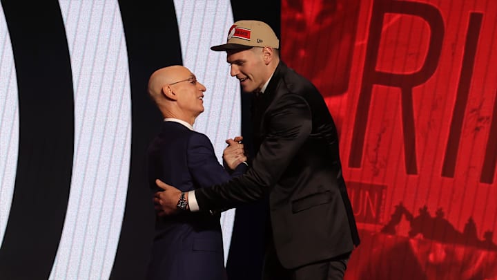 Jun 26, 2024; Brooklyn, NY, USA; Donovan Clingan shakes hands with NBA commissioner Adam Silver after being selected in the first round by the Portland Trail Blazers in the 2024 NBA Draft at Barclays Center. Mandatory Credit: Brad Penner-Imagn Images