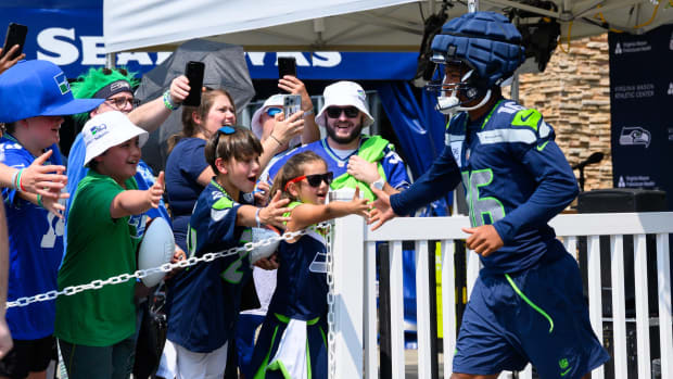 Seattle Seahawks wide receiver Tyler Lockett (16) runs out of the locker room before training camp.