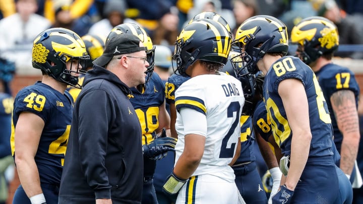 Michigan tight ends coach Steve Casula huddles with players at warmup of the spring game at Michigan Stadium in Ann Arbor on Saturday, April 20, 2024.