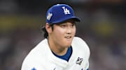 Oct 28, 2025; Los Angeles, California, USA; Los Angeles Dodgers two-way player Shohei Ohtani (17) throws to first for an out against Toronto Blue Jays third baseman Addison Barger (47)