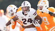 Mississippi State running back Fluff Bothwell (24) runs the ball while defended by Tennessee defensive lineman Joshua Josephs (19) during a college football game between Tennessee and Mississippi State at Davis Wade Stadium in Starkville, Miss., on Sept. 27, 2025.