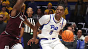 Dec 2, 2025; Pittsburgh, Pennsylvania, USA;  Pittsburgh Panthers guard Omari Witherspoon (8) drives to the basket against Texas A&M Aggies guard Josh Holloway (1) during the first half at the Petersen Events Center. Mandatory Credit: Charles LeClaire-Imagn Images