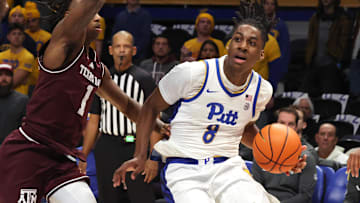 Dec 2, 2025; Pittsburgh, Pennsylvania, USA;  Pittsburgh Panthers guard Omari Witherspoon (8) drives to the basket against Texas A&M Aggies guard Josh Holloway (1) during the first half at the Petersen Events Center. Mandatory Credit: Charles LeClaire-Imagn Images