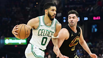 Mar 5, 2024; Cleveland, Ohio, USA;  Boston Celtics forward Jayson Tatum (0) drives to the basket against Cleveland Cavaliers forward Georges Niang (20) during the first half at Rocket Mortgage FieldHouse. Mandatory Credit: Ken Blaze-Imagn Images