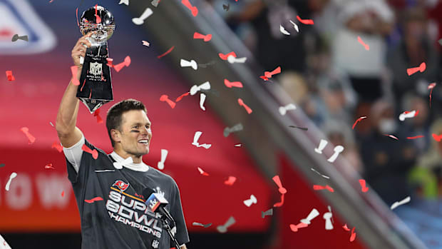 Tampa, FL, USA; Tampa Bay Buccaneers quarterback Tom Brady (12) hoists the Vince Lombardi Trophy after defeating the Kansas C