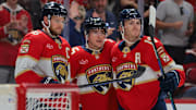 Nov 30, 2024; Sunrise, Florida, USA; Florida Panthers right wing Mackie Samoskevich (center) celebrates with center Aleksander Barkov (left) and left wing Matthew Tkachuk (right) after scoring against the Carolina Hurricanes during the second period at Amerant Bank Arena. Mandatory Credit: Sam Navarro-Imagn Images
