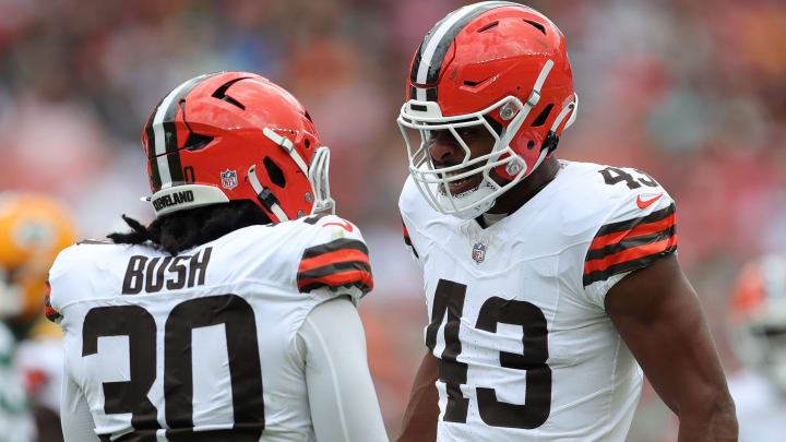 Cleveland Browns linebacker Devin Bush (30) and Cleveland Browns linebacker Mohamoud Diabate (43) celebrate a stop against the Green Bay Packers during the first half of an NFL preseason football game at Cleveland Browns Stadium, Saturday, Aug. 10, 2024, in Cleveland, Ohio.