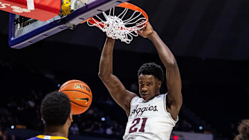 Mar 8, 2025; Baton Rouge, Louisiana, USA;  Texas A&M Aggies forward Pharrel Payne (21) dunks the ball against LSU Tigers forward Robert Miller III (6) during the second half at Pete Maravich Assembly Center. Mandatory Credit: Stephen Lew-Imagn Images