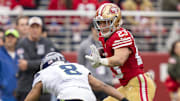 November 17, 2024; Santa Clara, California, USA; San Francisco 49ers running back Christian McCaffrey (23) runs against Seattle Seahawks cornerback Coby Bryant (8) during the second quarter at Levi's Stadium. Mandatory Credit: Kyle Terada-Imagn Images