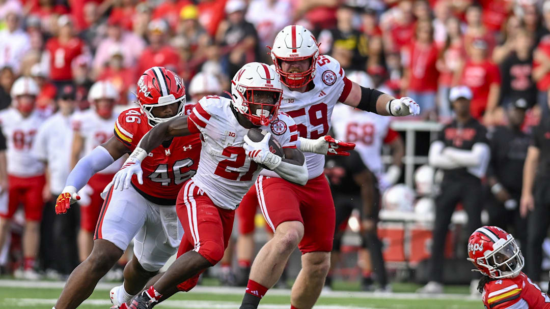 Nebraska Cornhuskers running back Emmett Johnson (21) rushes as Maryland Terrapins defensive lineman Dillan Fontus (46) pursues during the first half at SECU Stadium.