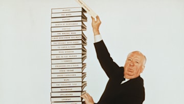 Alfred Hitchcock and a Stack of His Scripts