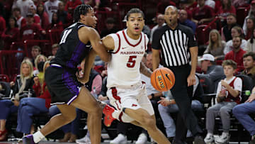 Nov 11, 2025; Fayetteville, Arkansas, USA; Arkansas Razorbacks guard Darius Acuff Jr (5) drives against UCA Bears guard Rashad Bolden (11) during the first half at Bud Walton Arena. Arkansas won 93-56. Mandatory Credit: Nelson Chenault-Imagn Images