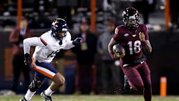 Nov 30, 2024; Blacksburg, Virginia, USA; Virginia Tech Hokies quarterback William Watson III (18) runs the ball during the first quarter against the Virginia Cavaliers at Lane Stadium. Mandatory Credit: Peter Casey-Imagn Images