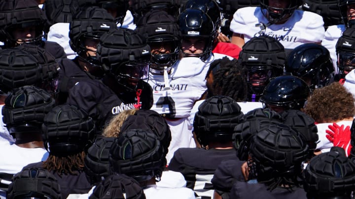 Players huddle before a scrimmage, Saturday, Aug. 10, 2024, at Nippert Stadium in Cincinnati.