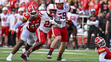 Oct 11, 2025; College Park, Maryland, USA;  Nebraska Cornhuskers running back Emmett Johnson (21) rushes as Maryland Terrapins defensive lineman Dillan Fontus (46) pursues during the first half at SECU Stadium. Mandatory Credit: Tommy Gilligan-Imagn Images
