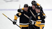 Dec 3, 2024; Pittsburgh, Pennsylvania, USA;  Pittsburgh Penguins defenseman Owen Pickering (middle) celebrates with left wing Anthony Beauvillier (72) and defenseman Ryan Shea (5) after scoring his first career NHL goal against the Florida Panthers during the first period at PPG Paints Arena. Mandatory Credit: Charles LeClaire-Ima