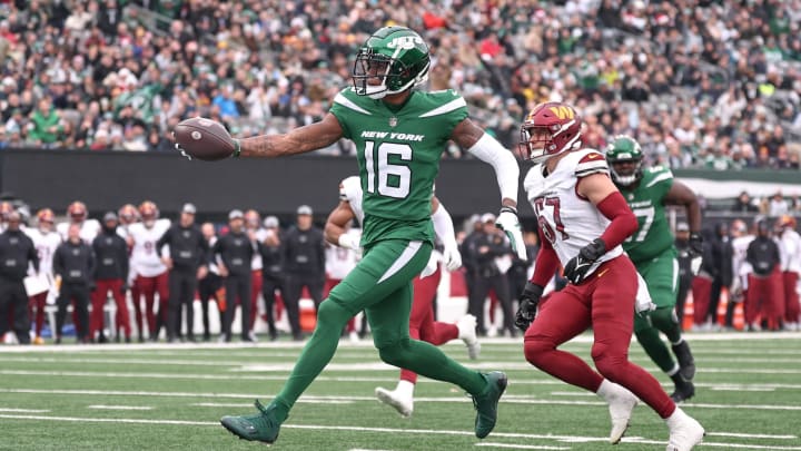 Dec 24, 2023; East Rutherford, New Jersey, USA; New York Jets wide receiver Jason Brownlee (16) scores a receiving touchdown during the first quarter against the Washington Commanders at MetLife Stadium. 