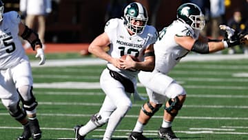 Oct 31, 2020; Ann Arbor, Michigan, USA;  Michigan State Spartans quarterback Rocky Lombardi (12) rushes against the Michigan Wolverines at Michigan Stadium. Mandatory Credit: Rick Osentoski-Imagn Images
