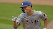 Jun 12, 2025; Minneapolis, Minnesota, USA; Texas Rangers center fielder Evan Carter (32) celebrates his solo home run against the Minnesota Twins in the fifth inning at Target Field