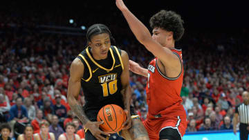 Mar 8, 2024; Dayton, Ohio, USA;  Virginia Commonwealth Rams forward Toibu \"Tobi\" Lawal (10) battles against Dayton Flyers forward Nate Santos (2) during the first half of the game at University of Dayton Arena. Mandatory Credit: Matt Lunsford-USA TODAY Sports