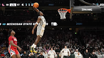 Mar 28, 2025; Atlanta, GA, USA; Michigan State Spartans forward Coen Carr (55) dunks against Mississippi Rebels forward Malik Dia (0) in the second half of a South Regional semifinal of the 2025 NCAA tournament at State Farm Arena. Mandatory Credit: Dale Zanine-Imagn Images