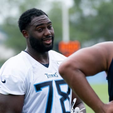 Titans Nicholas Petit-Frere (78) talks with a teammate after practice at the Tennessee Titans practice facility, Ascension St. Thomas Sports Park, Wednesday, July 26, 2023.