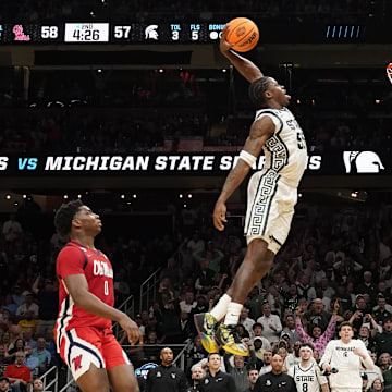 Mar 28, 2025; Atlanta, GA, USA; Michigan State Spartans forward Coen Carr (55) dunks against Mississippi Rebels forward Malik Dia (0) in the second half of a South Regional semifinal of the 2025 NCAA tournament at State Farm Arena. Mandatory Credit: Dale Zanine-Imagn Images