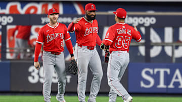 Jun 18, 2025; Bronx, New York, USA; Los Angeles Angels center fielder Jo Adell (7) and first baseman LaMonte Wade Jr. (35) and left fielder Taylor Ward (3) celebrate after defeating the New York Yankees at Yankee Stadium. Mandatory Credit: Vincent Carchietta-Imagn Images