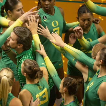 Oregon volleyball coach Matt Ulmer brings his team together during their match against Oregon State in Eugene Friday, Sept. 22, 2023.