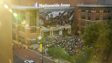 Sep 4, 2024; Columbus, OH, USA; Mourners gather for a candlelight vigil to remember Columbus Blue Jackets forward Johnny Gaudreau at Nationwide Arena. Gaudreau, along with his brother, Matthew, died in a bicycle crash last week. Mandatory Credit: Adam Cairns-Imagn Images via Columbus Dispatch/USA TODAY Network