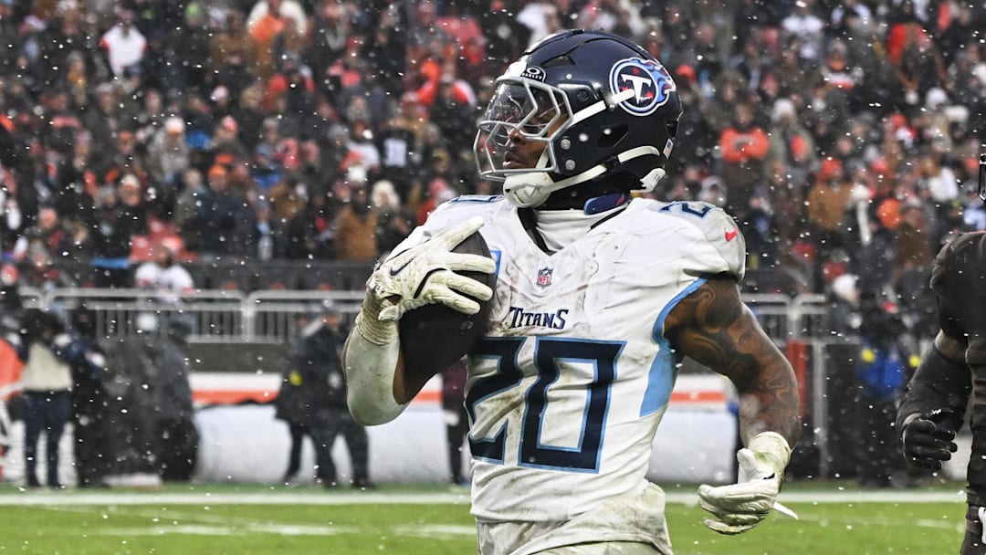 Dec 7, 2025; Cleveland, Ohio, USA; Tennessee Titans running back Tony Pollard (20) runs for a thirty-two yard touchdown against Cleveland Browns safety Grant Delpit (9) during the third quarter at Huntington Bank Field. Mandatory Credit: Ken Blaze-Imagn Images