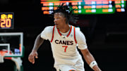 Nov 23, 2025; Coral Gables, Florida, USA; Miami Hurricanes forward Shelton Henderson (7) drives to the basket against Delaware State Hornets guard John Clemmons (5) during the second half at Watsco Center. Mandatory Credit: Sam Navarro-Imagn Images