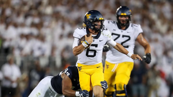 Sep 2, 2023; University Park, Pennsylvania, USA; West Virginia Mountaineers quarterback Garrett Greene (6) runs with the ball while trying to avoid a tackle during the third quarter against the Penn State Nittany Lions at Beaver Stadium. Penn State defeated West Virginia 38-15.