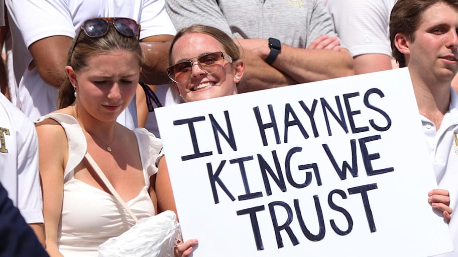 A Yellow Jackets fan holds a sign for quarterback Haynes King.