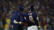 Sep 26, 2025; Charlottesville, Virginia, USA; Virginia Cavaliers head coach Tony Elliott (L) watches a video review of a called targeting penalty on Cavaliers safety Antonio Clary (0) against the Florida State Seminoles during the second quarter at Scott Stadium. Mandatory Credit: Geoff Burke-Imagn Images