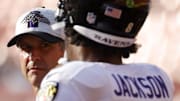 Aug 28, 2021; Landover, Maryland, USA; Baltimore Ravens head coach John Harbaugh (L) talks with Ravens quarterback Lamar Jackson (8) during warmups prior to their game against the Washington Football Team at FedExField. Mandatory Credit: Geoff Burke-Imagn Images
