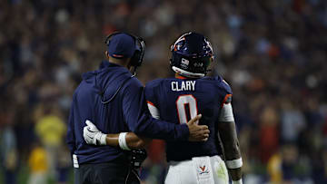 Sep 26, 2025; Charlottesville, Virginia, USA; Virginia Cavaliers head coach Tony Elliott (L) watches a video review of a called targeting penalty on Cavaliers safety Antonio Clary (0) against the Florida State Seminoles during the second quarter at Scott Stadium. Mandatory Credit: Geoff Burke-Imagn Images