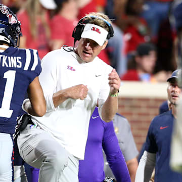 Sep 16, 2023; Oxford, Mississippi, USA; Mississippi Rebels wide receiver Jordan Watkins (11) reacts with Mississippi Rebels head coach Lane Kiffin (right) after a touchdown during the second half against the Georgia Tech Yellow Jackets at Vaught-Hemingway Stadium. Mandatory Credit: Petre Thomas-Imagn Images