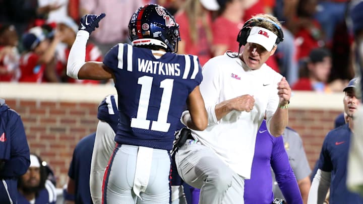 Sep 16, 2023; Oxford, Mississippi, USA; Mississippi Rebels wide receiver Jordan Watkins (11) reacts with Mississippi Rebels head coach Lane Kiffin (right) after a touchdown during the second half against the Georgia Tech Yellow Jackets at Vaught-Hemingway Stadium. Mandatory Credit: Petre Thomas-Imagn Images