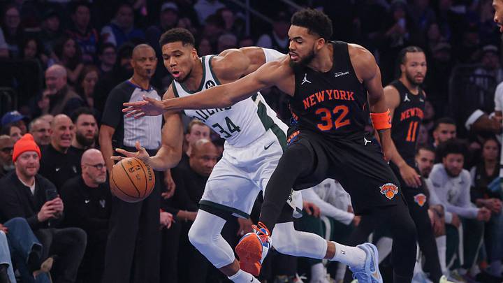 Nov 28, 2025; New York, New York, USA;  Milwaukee Bucks forward Giannis Antetokounmpo (34) and New York Knicks center Karl-Anthony Towns (32) battle for the ball during the first half at Madison Square Garden. Mandatory Credit: Vincent Carchietta-Imagn Images