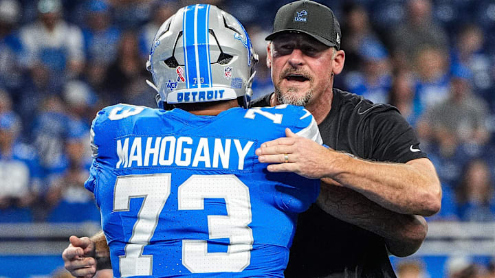 Detroit Lions head coach Dan Campbell hugs guard Christian Mahogany (73) during warm-up at Ford Field in Detroit on Sunday, Sept. 14, 2025.